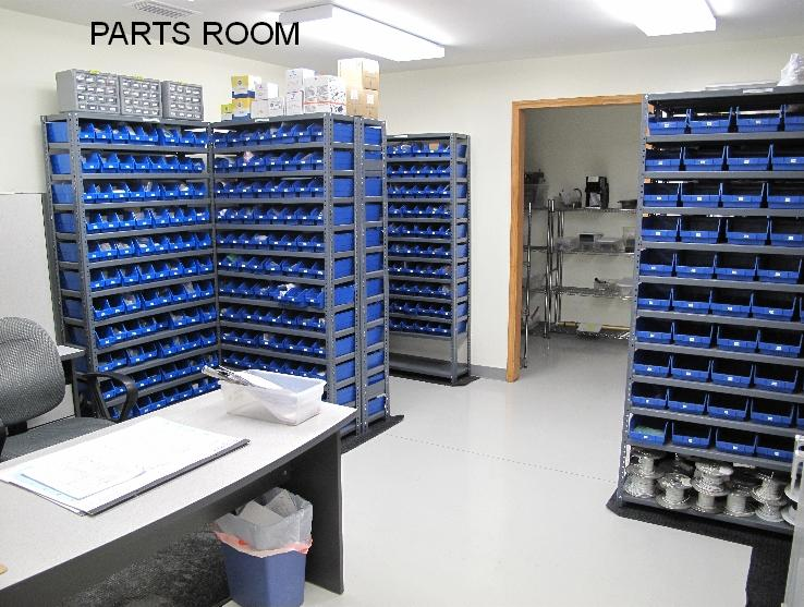 A room filled with lots of shelves and blue bins.